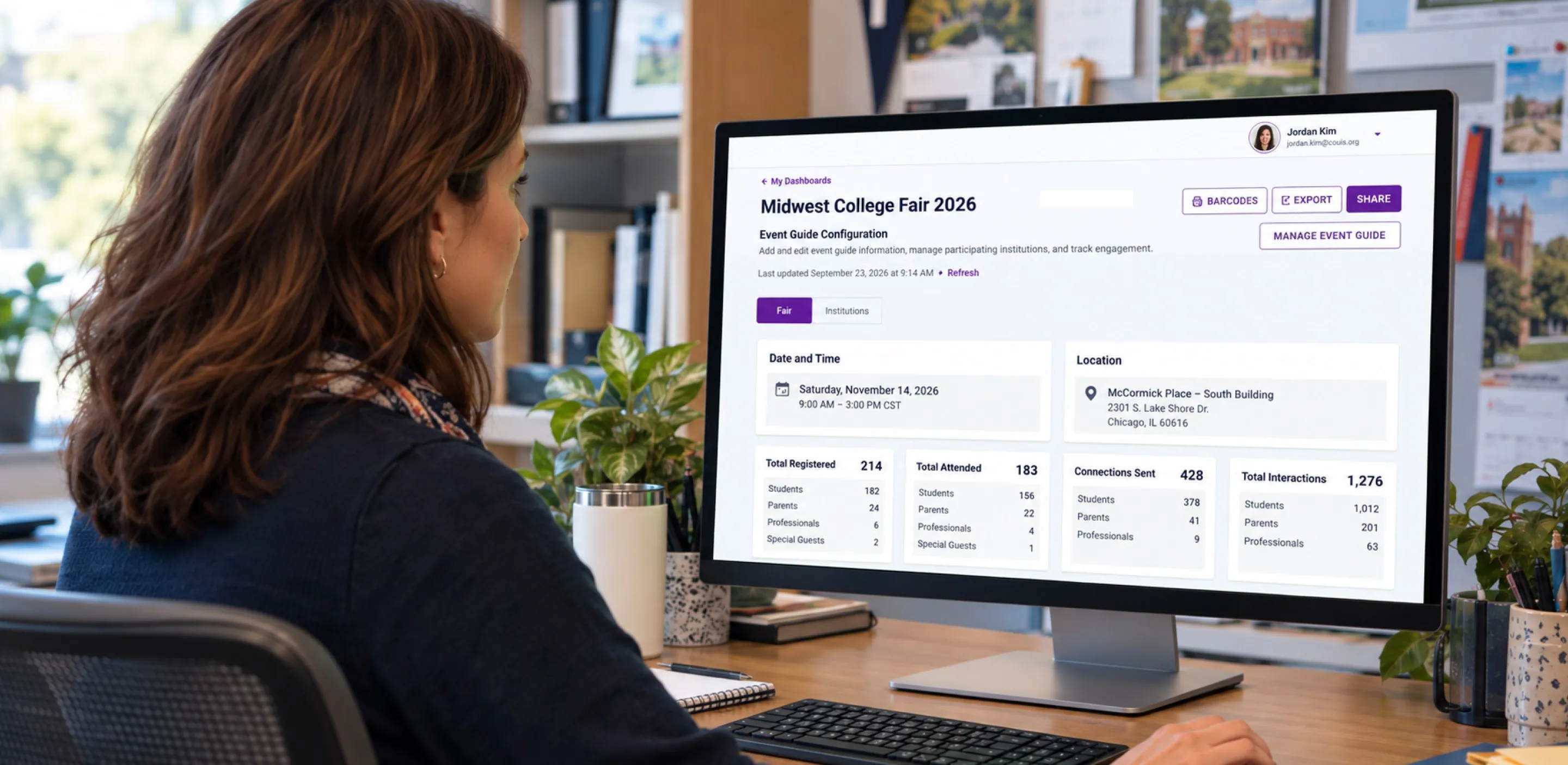 An administrator reviewing a fair's registration summary on a desktop monitor